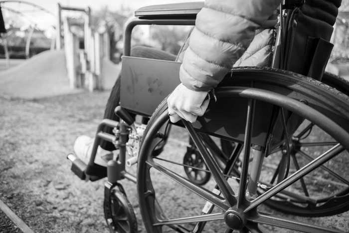 black and white image of person in a wheelchair